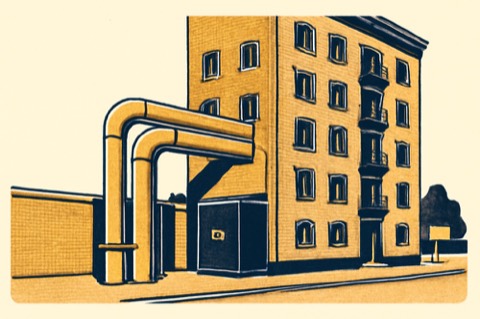 District-heating service pipes entering a Munich apartment building with a compact heat-exchanger cabinet.