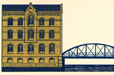 Brick townhouse on a Hamburg canal with footbridge