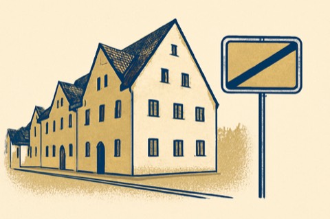 Bayerische Mietshäuser nahe einem Gemeindegrenz-Schild
